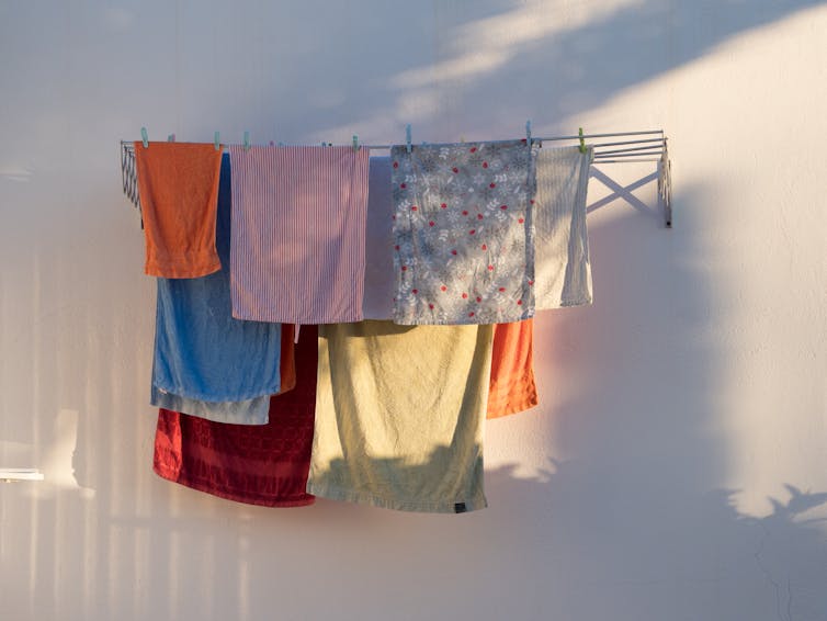 Tea towels drying on a clothesline.