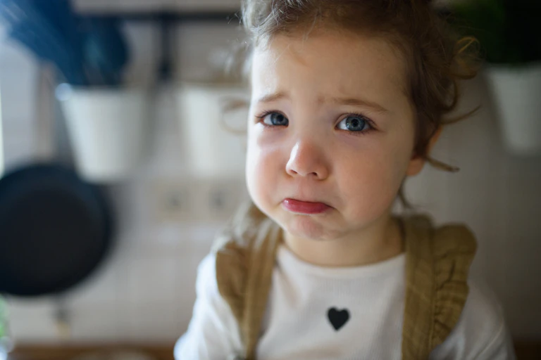 Preschooler with runny nose about to cry