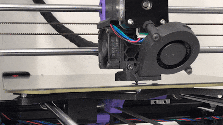 Video of a 3D printer laying down different colours in a single oval tablet