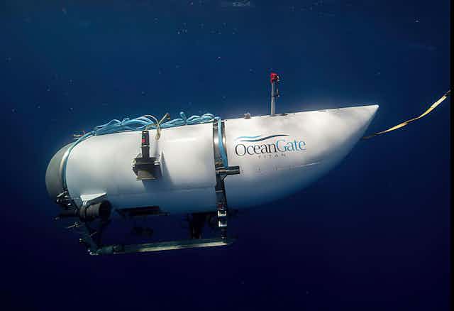 A white cylinder shaped tube with 'ocean gate titan' written on it
