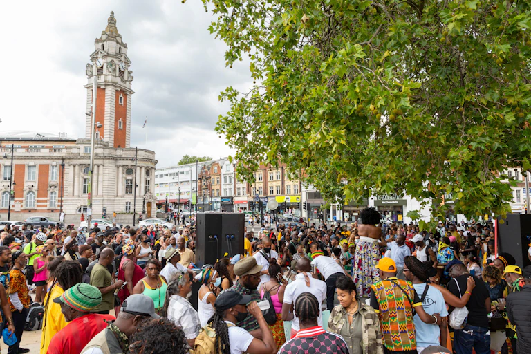 A crowd under a tree on a square.