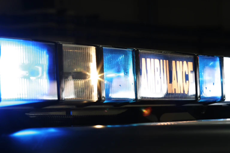 Flashing lights of an ambulance at night.