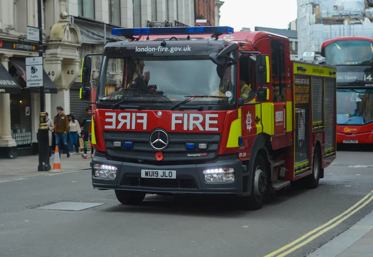 A fire engine driving down a road.