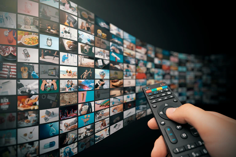 A person pointing a remote at a never ending TV screen.