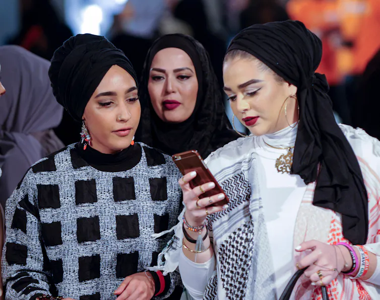 Spectators at a fashion show.