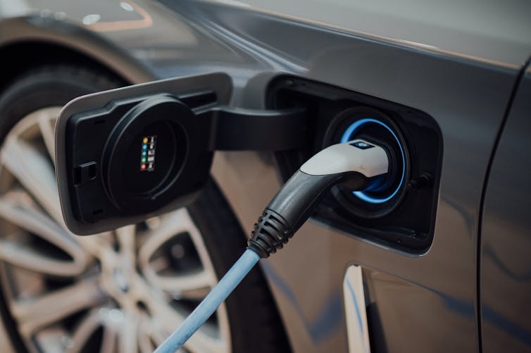 A charger plugged into an electric car.