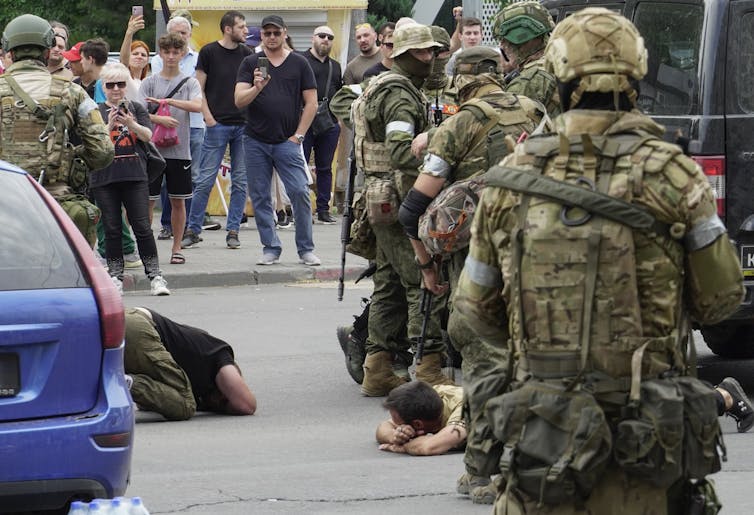 Armed militia men on a street in Russia