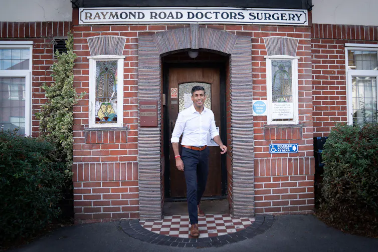 Rishi Sunak outside the entrance of a GP surgery