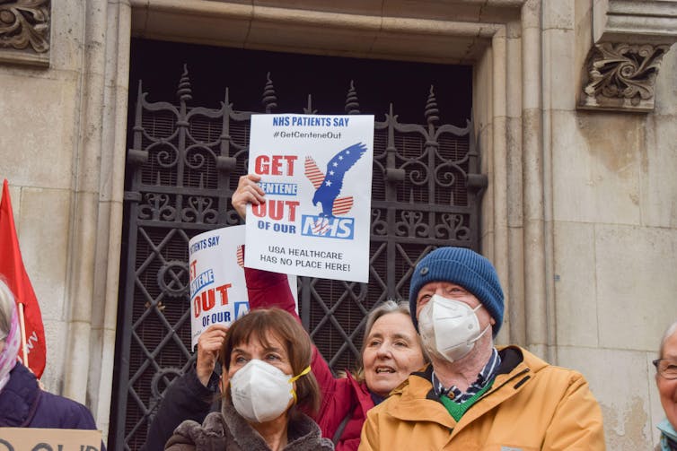 Protesters with placards outside the Royal Courts of Justice in London