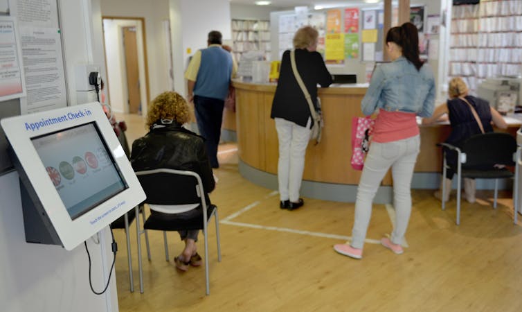 Patients inside a GP waiting room