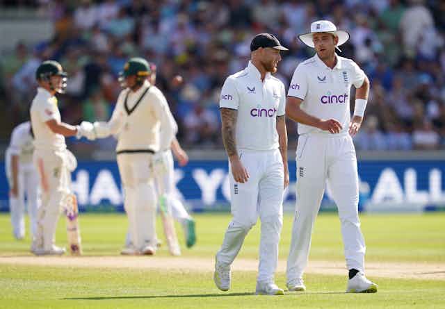 England captain Ben Stokes (second right) speaks to Stuart Broad during day four of the first Ashes test match. They both wear their England whites. 