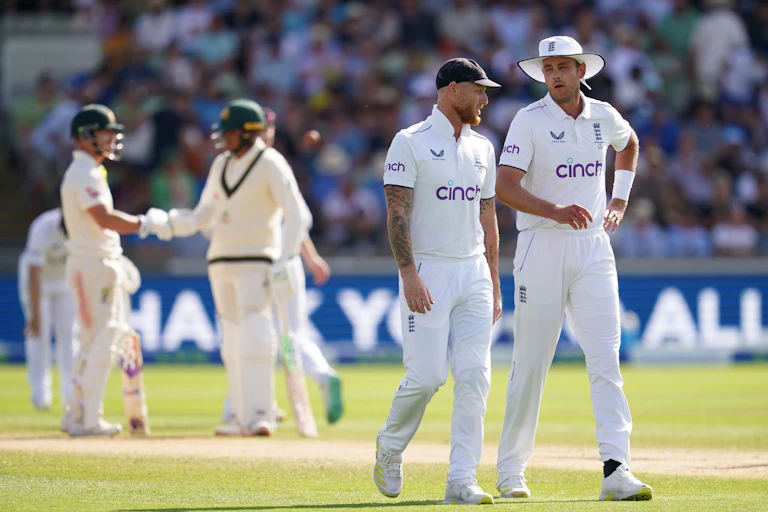 England captain Ben Stokes (second right) speaks to Stuart Broad during day four of the first Ashes test match. They both wear their England whites.
