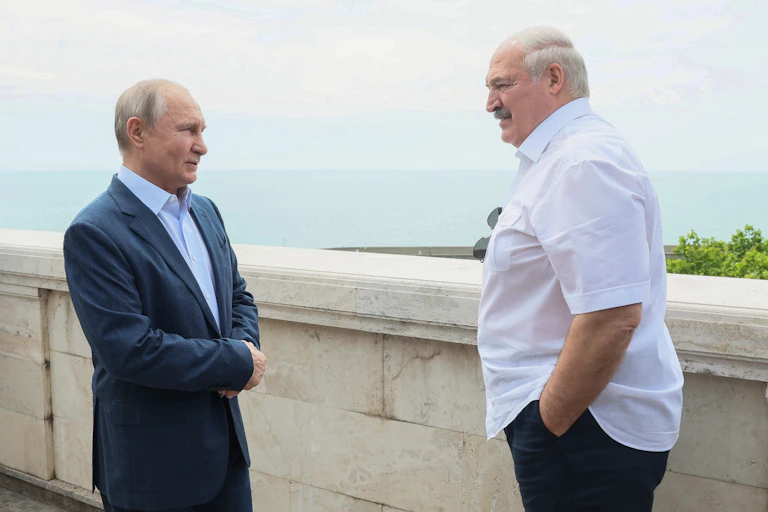 Vladimir Putin and Alexander Lukashenko talk on a terrace overlooking the sea