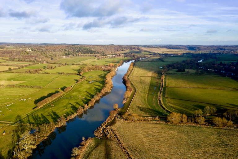 aerial view of a river surrounded by fields