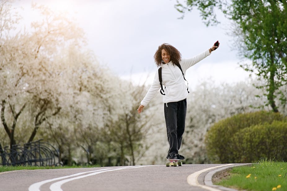 Teenage girl balancing on a skateboard