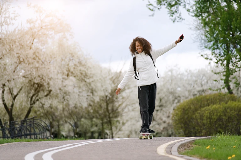 Teenage girl balancing on a skateboard