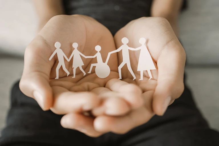 paper cutouts of figures include some walking and in wheelchair