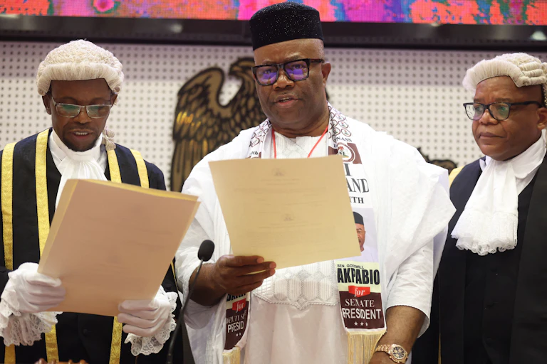 A man being sworn in standing between two other men