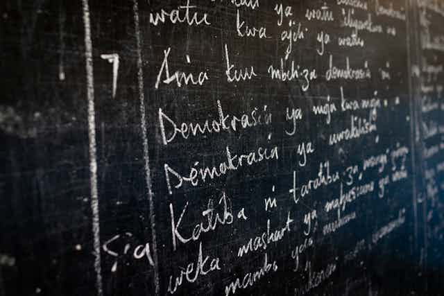 Swahili language writing on a blackboard.