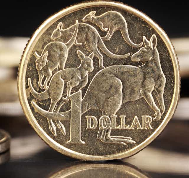 A $1 coin on a desk