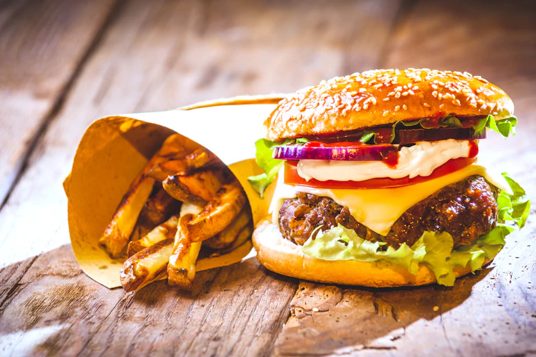 Burger and chips on a wooden platter