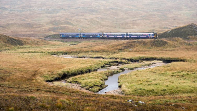 Remote train line with peat bog in foreground