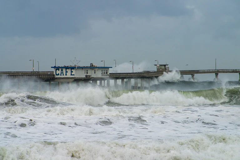 Stormy waves crashing into a pier.