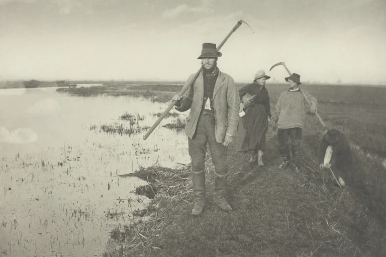 1886 black and white photo of three country people by a marsh with tools