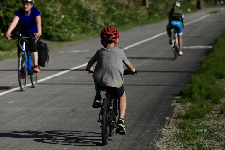 A child cycling on a bike path.