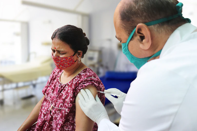 A woman receives a vaccination.