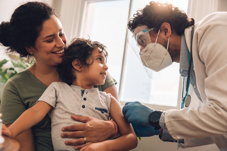 A small boy receives a vaccine.