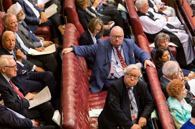 Eric Pickles sitting on the benches of the House of Lords alongside fellow peers. 
