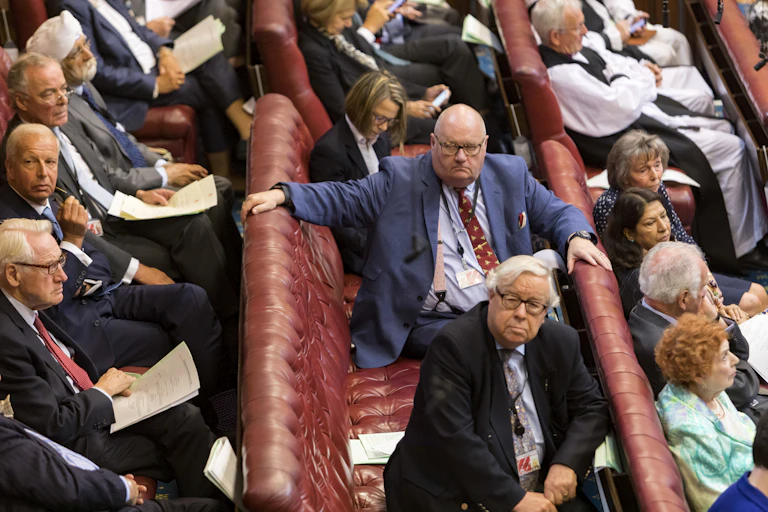 Eric Pickles sitting on the benches of the House of Lords alongside fellow peers.