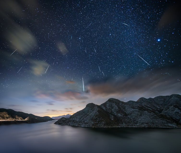 Photo showing a dark sky with several bright streaks representing meteors.