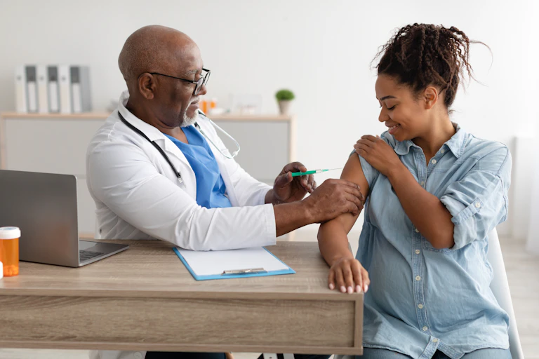 A pregnant woman getting vaccinated