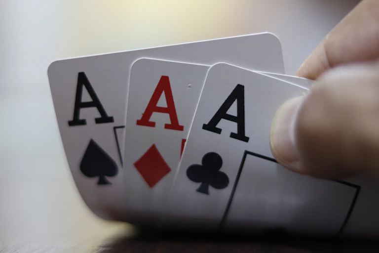 Card hand holding three Aces