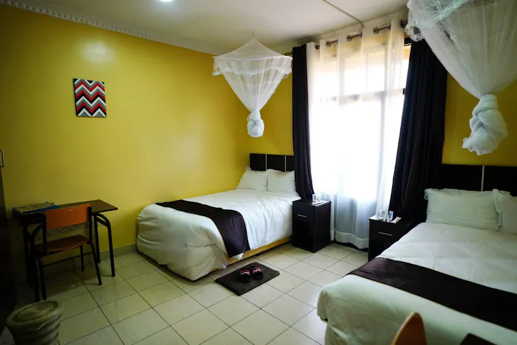 Two beds in a shared hostel room which is clean but basic.