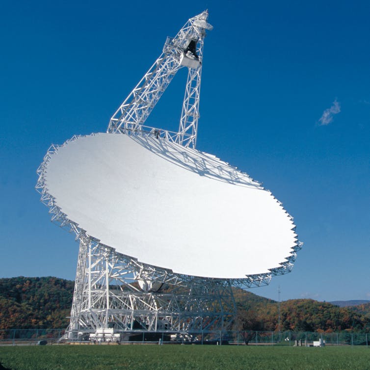 A giant, white reflecting dish with a receiver.