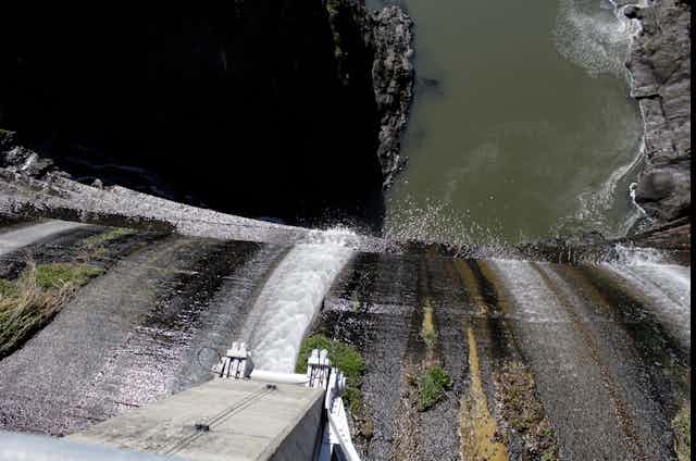 View from the top of a dam with water running over