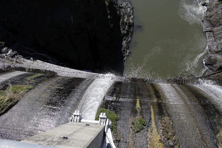 View from the top of a dam with water running over