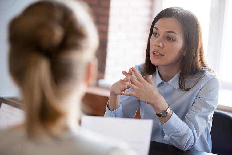 Female employer explaining something to a junior worker