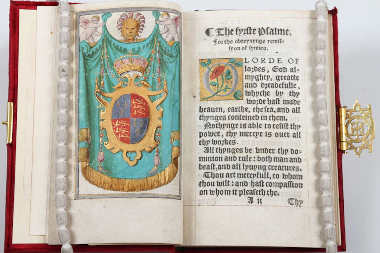 An open book with pearl placeholders, showing the title page of Psalms and Prayers.