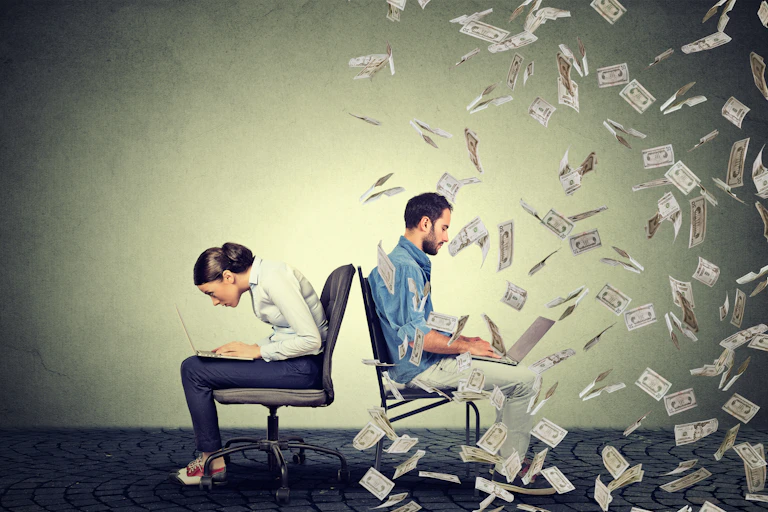 Woman sitting on desk chair, hunched over laptop. Man sitting straighter on desk chair, typing on laptop, surrounded by floating bank notes.