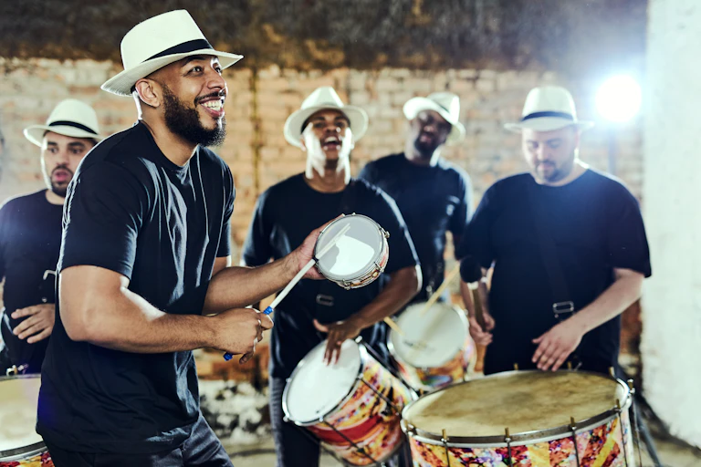 five percussionists in black tees and white hats