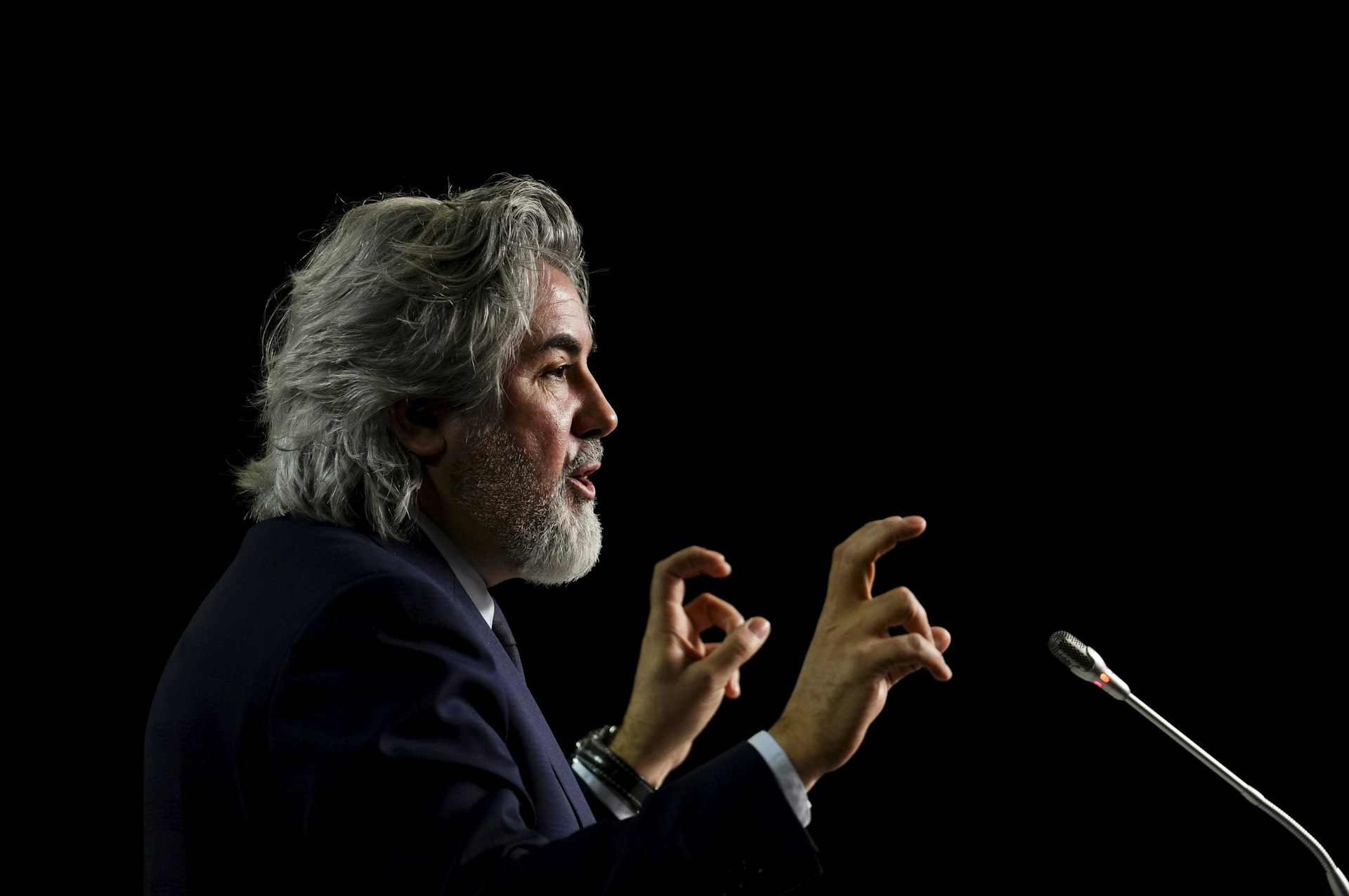 Rodriguez speaks into a microphone