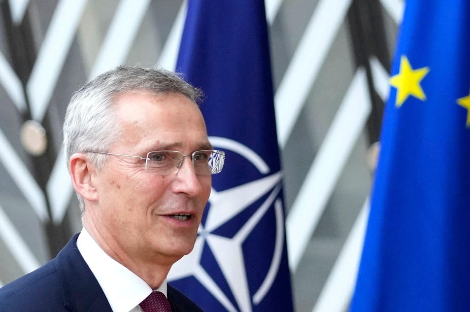 Nato secretary general Jens Stoltenberg in front of the Nato and EU flags