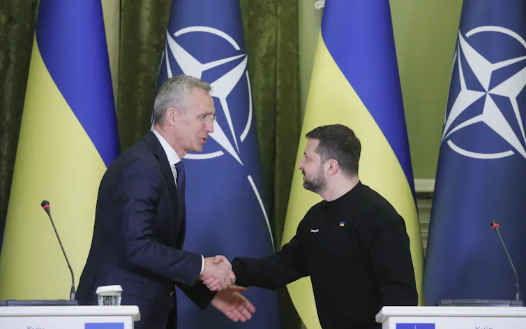 Nato secretary general Jens Stoltenberg shakes hands with Ukraine's president Volodymyr Zelensky.
