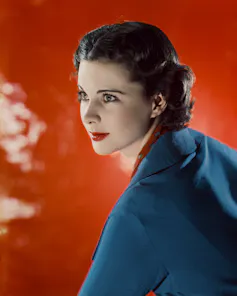 A photograph of Vivien Leigh against a red background.