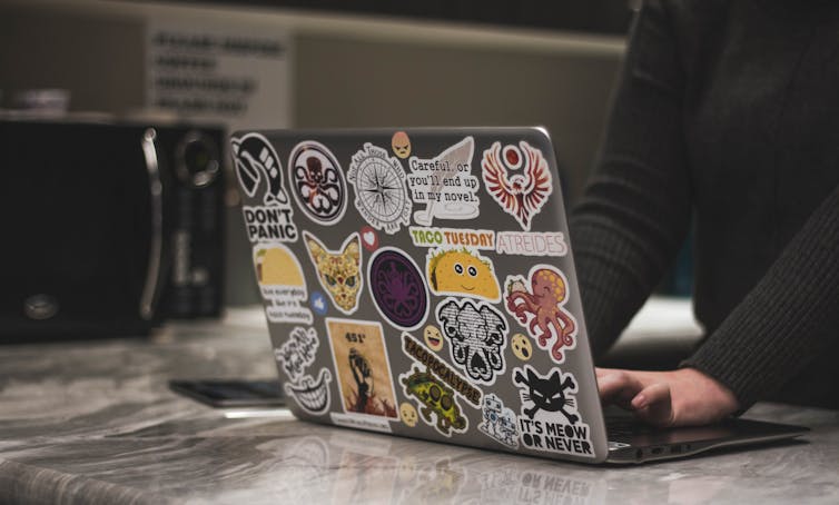 A laptop covered in stickers.