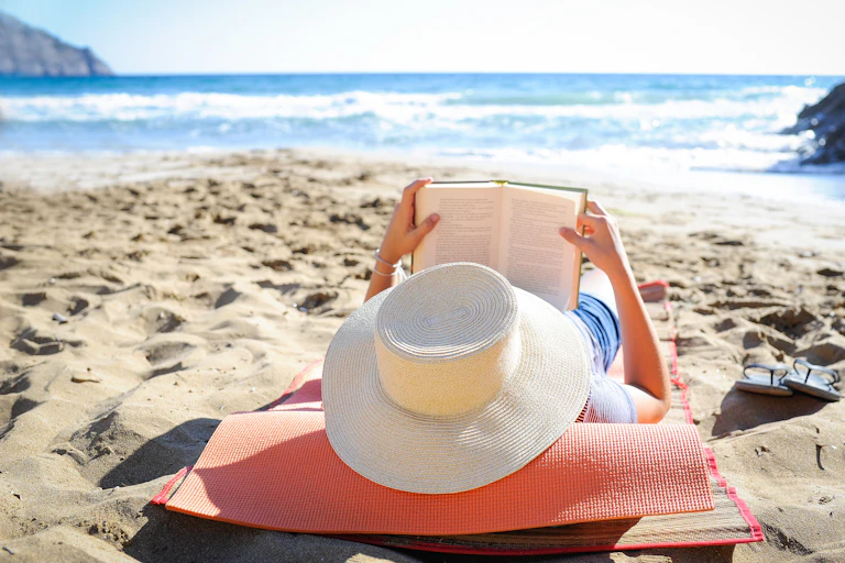 Woman reading on the beach.
